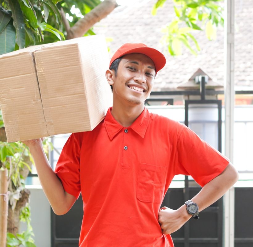 delivery-man-delivers-the-box-in-front-of-the-customer-s-house.jpg